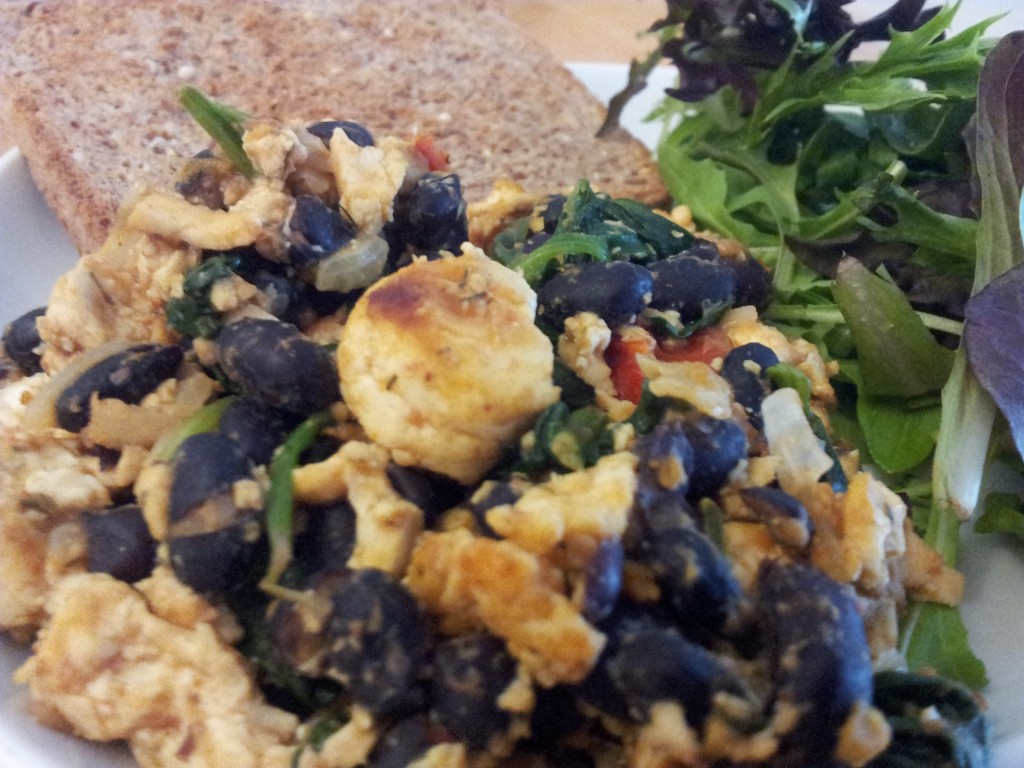 Vegan tofu scramble with greens and toast on the side